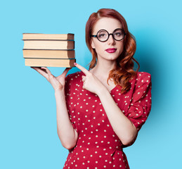 girl in red dress with books