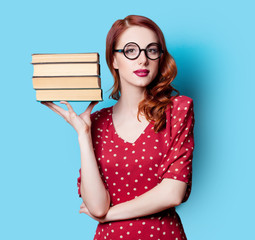 girl in red dress with books