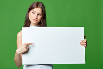 Beautiful woman gesticulating, holding white blank advertising 