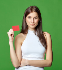 Happy smiling girl in casual clothing, showing blank credit card