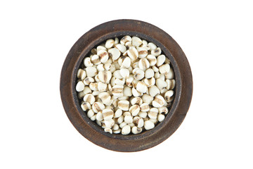 Millet in wood bowl on isolated white