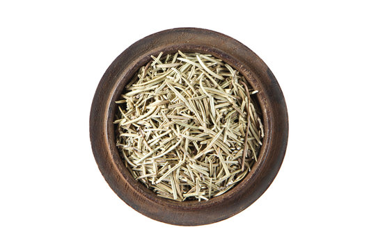 Rosemary dried in wood bowl on isolated white., Top view