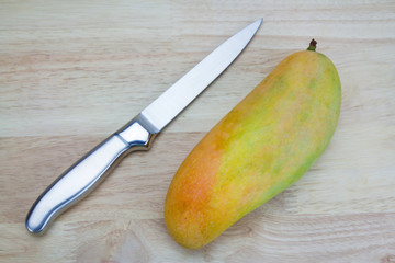 Mango on a wooden background