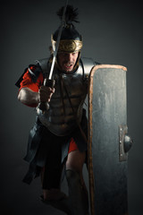 Roman legionary with sword and shield in the attack
