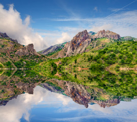 Reflection of the mountains in the clear water lake in the summe