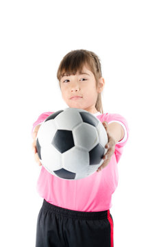 Little happy girl in pink holding soccer ball on white backgroun
