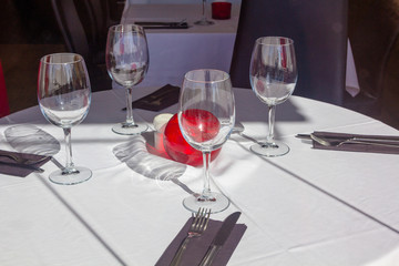 restaurant tables with silverware and glasses ready for a lunch