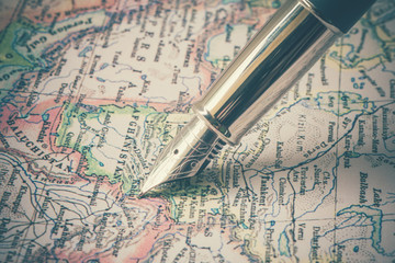 Fototapeta na wymiar Pen and a map with filter effect retro vintage style