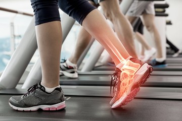 Highlighted ankle of woman on treadmill - obrazy, fototapety, plakaty