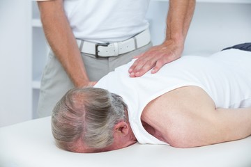 Fototapeta na wymiar Physiotherapist doing shoulder massage to his patient