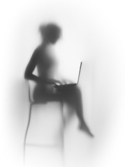 Naklejka premium Silhouette of a pretty, slim woman with laptop and chair