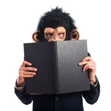 ape man hiding behind a book