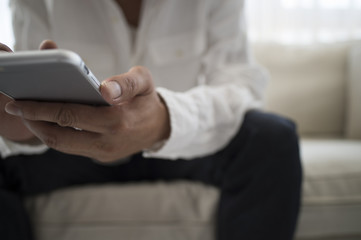 Men have a smart phone sitting on the sofa