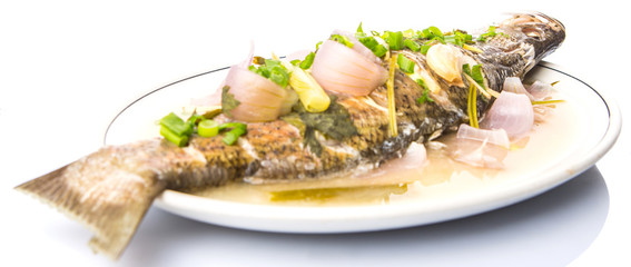 Malaysian dish of sweet and sour steamed Asian bass fish - 84027776