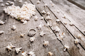 gentle white heart shape flowers with ring on wood table