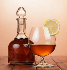 Cognac in bottle and glass with lemon