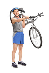 Active senior biker carrying his bicycle