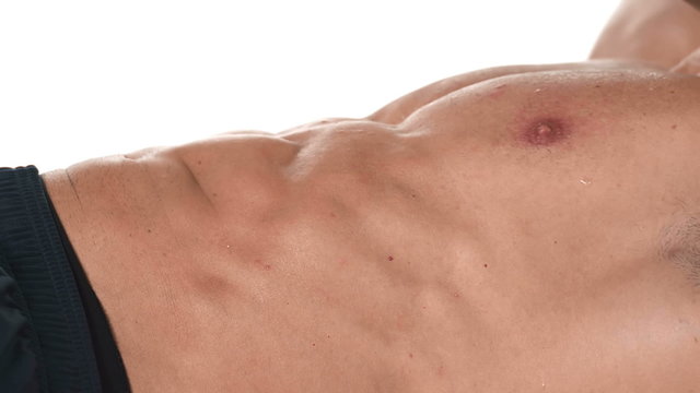 Close up shot of a muscular bodybuilder doing ab exercises and sit ups