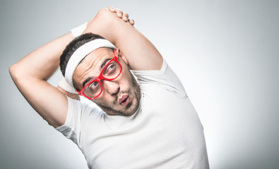Closeup funny nerd doing aerobics isolated on gray background