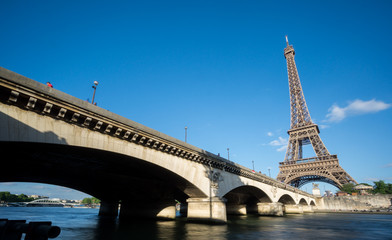 Fototapeta na wymiar The Eiffel Tower and bridge over Seine River in Paris