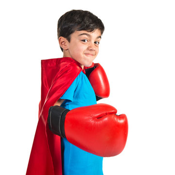 Child dressed like superhero giving a punch