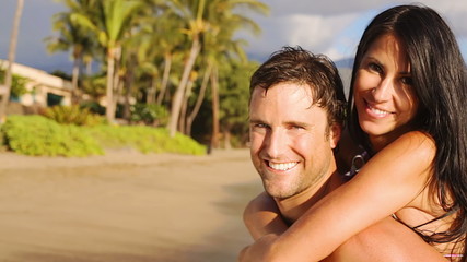 Medium shot of attractive mid adult couple looking at the camera and smiling