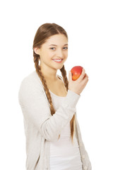 Teenage woman holding an apple.