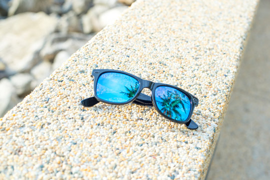 blue sunglass on the beach