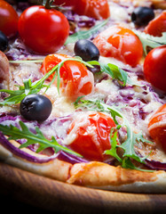 Pizza with cherry tomatoes and arugula