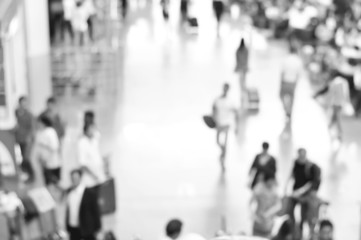 Blurred people at the airport hallway in black and white