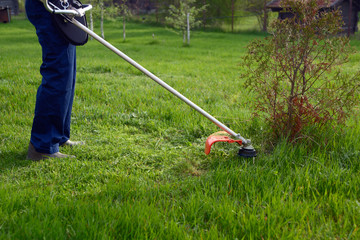 Man mows a grass