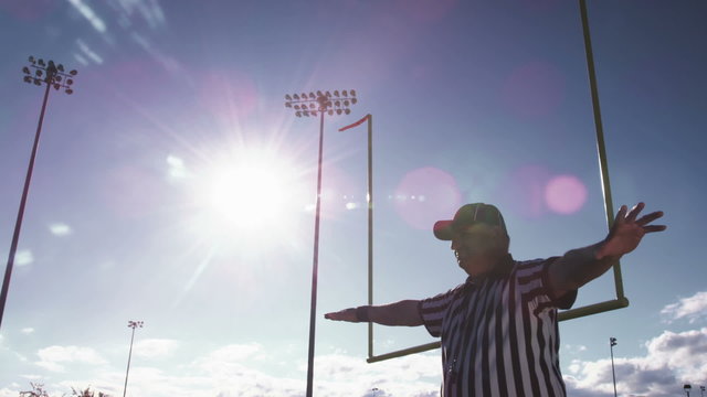 A football referee waves his arms back and forth for a missed field goal