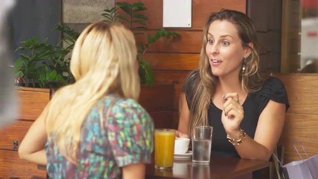 Mother and daughter talk at a cafe in Brazil