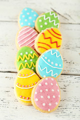 Colorful easter cookies on white wooden background