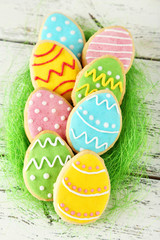 Colorful easter cookies on white wooden background