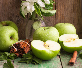 Green apples, mint and cinnamon on the table
