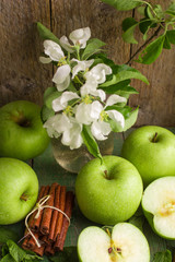 Green apples, mint and cinnamon on the table