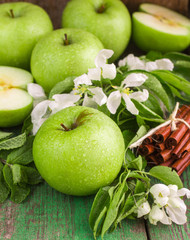 Green apples, mint and cinnamon on the table