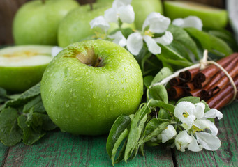 Green apples, mint and cinnamon on the table