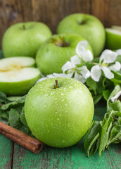 Green apples, mint and cinnamon on the table