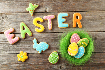 Colorful easter cookies on grey wooden background
