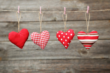 Love hearts hanging on rope on grey wooden background