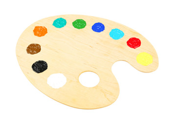 Wooden art palette with paints isolated on white