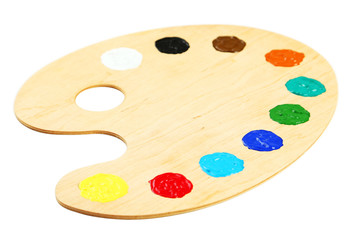 Wooden art palette with paints isolated on white
