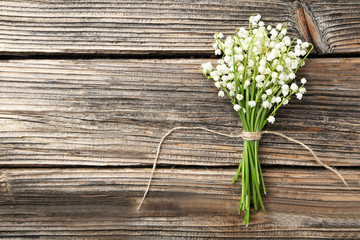 Lily of the Valley on brown wooden background