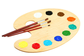 Wooden art palette with paints isolated on white