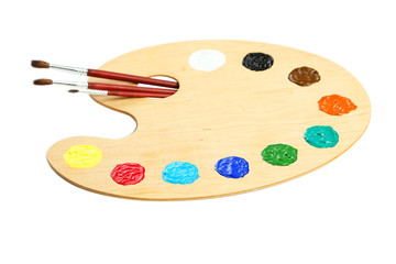 Wooden art palette with paints isolated on white