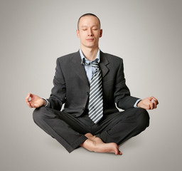 businessman in lotus pose meditating