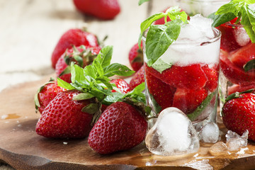 Strawberry cocktail with mint and ice, selective focus