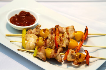 Delicious chicken shish served with sauce.